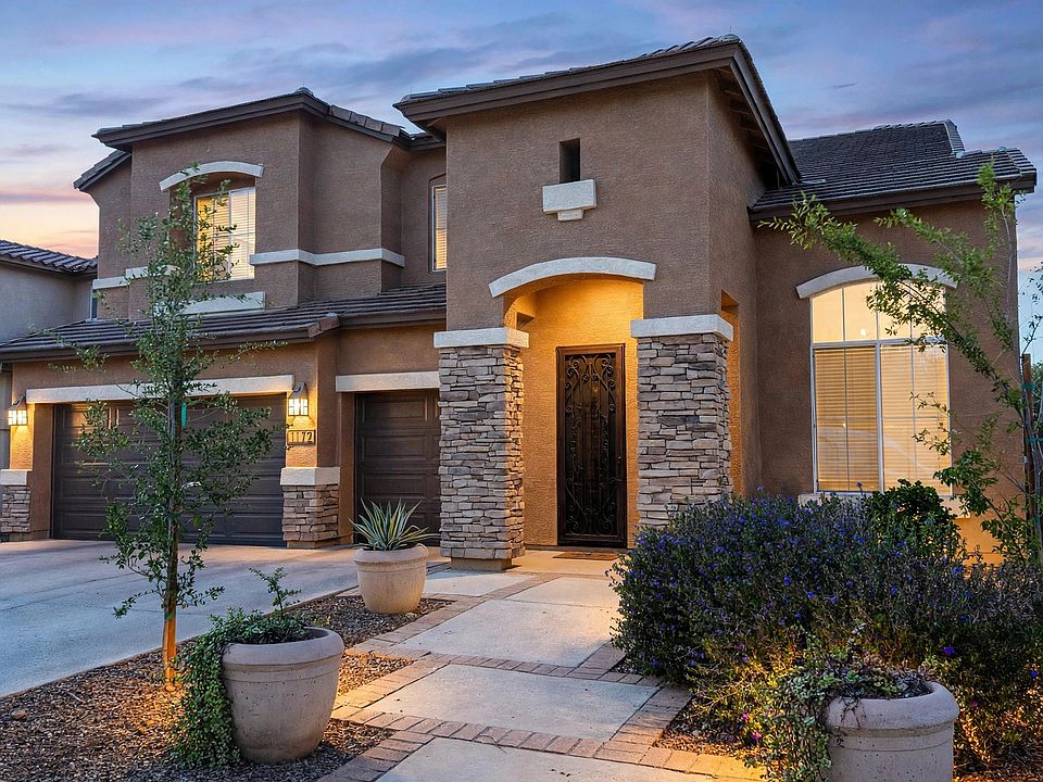 Front exterior of this spacious Camelot-built home in Artemina at The Islands, featuring a 3-car tandem garage.