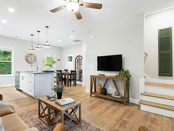 Front stairs, and wide view of open concept living area