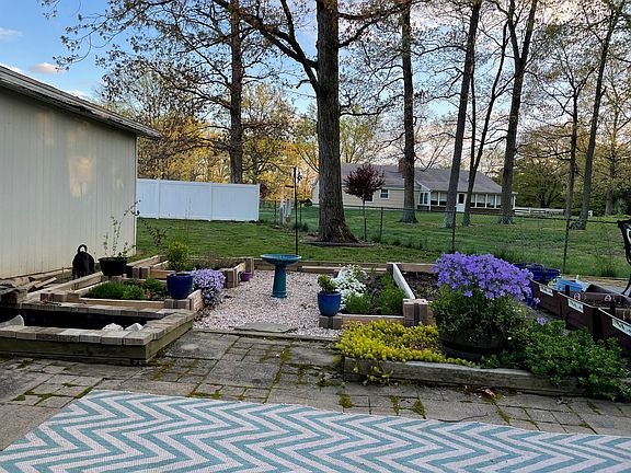 Back yard with flower garden and shed.