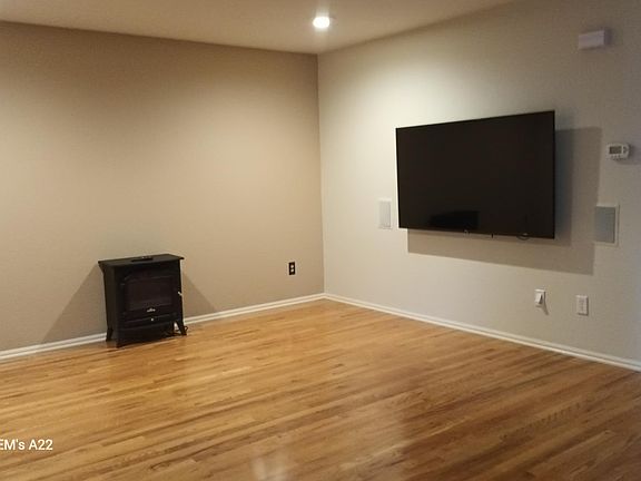Living Room with 65" smart TV and electric fire place.