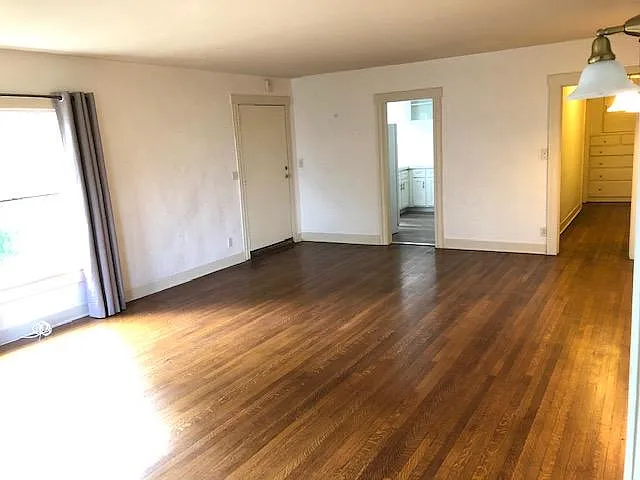 Far corner Livingroom facing front door, kitchen and hall