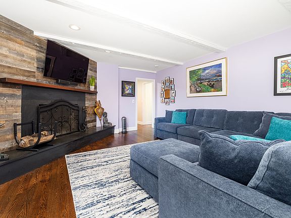 Family room with raised hearth woodburning fireplace