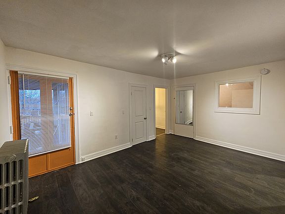 Entrance door and Living room, behind the mirrow there is a storage area