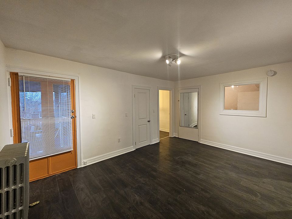 Entrance door and Living room, behind the mirrow there is a storage area