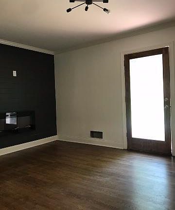 Family room with accent wall and sleek electric wall mount fireplace