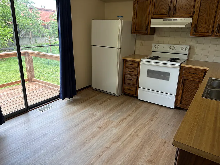 Kitchen/eating area with new flooring and back porch