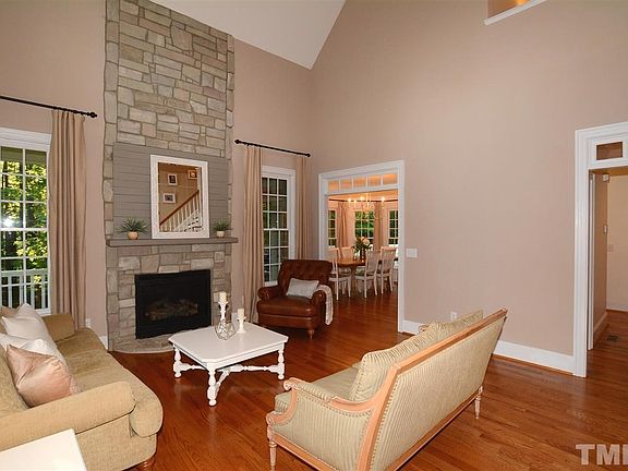 2-Story Living Room has a Floor to Ceiling Stone Natural Gas Fireplace & Decorative Mantle. This Room also has Transom openings to the Dining & Hallway Area.