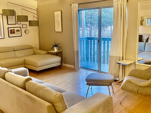 Vaulted ceiling in the living area and sliding glass doors to small trex deck and balcony overlooking front of the property.