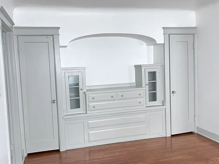 Huge walk-in closet behind built-in.