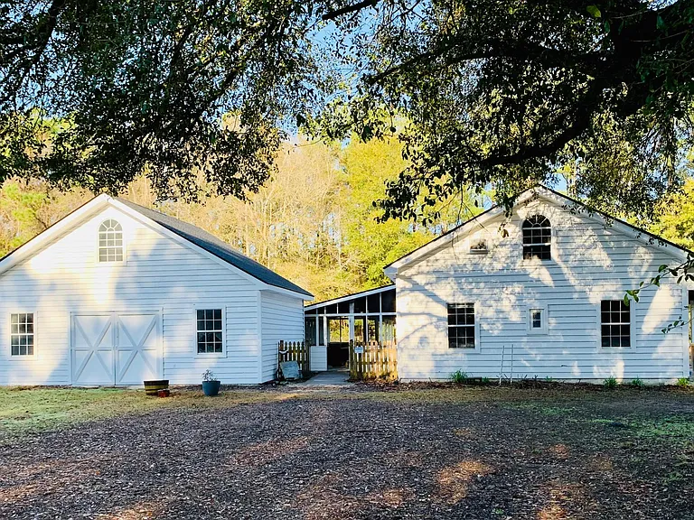 Large workshop on left, rear walkway to screened porch and house on the right.