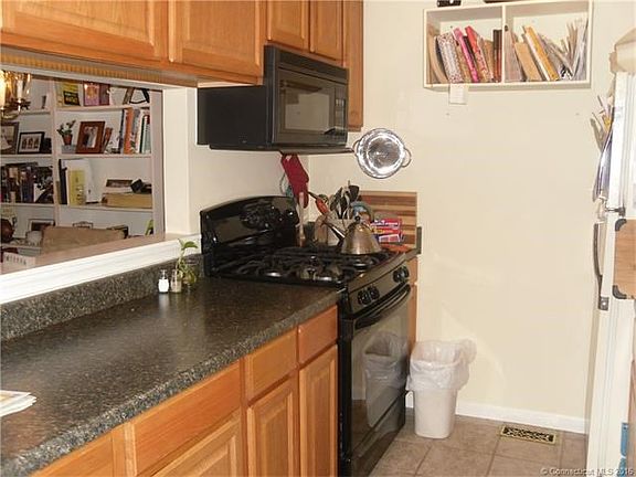 Galley style Kitchen has a gas range, microwave, dishwasher