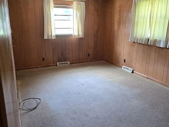 Small living room. Door for entry to the garage