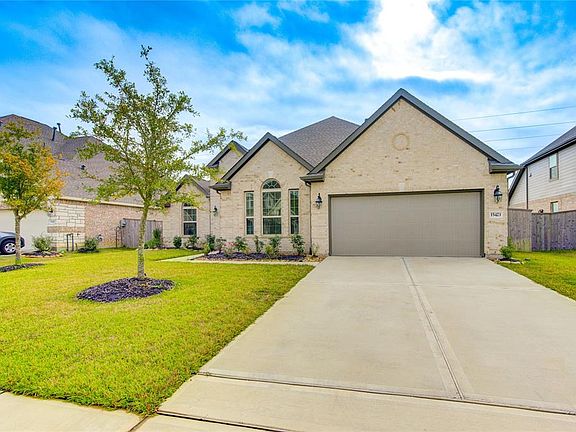 The 2-car garage has newer epoxy flooring (not pictured), and plenty of extra parking in the driveway.