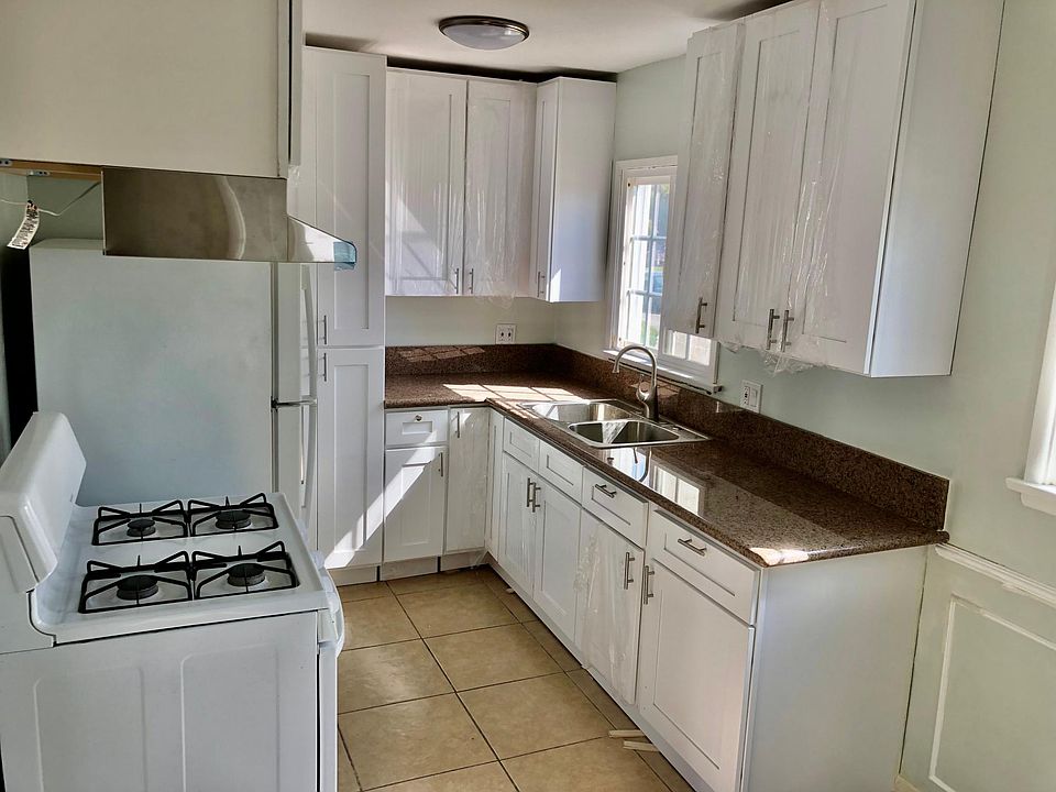 Newly updated kitchen with granite countertops and new white cabinetry