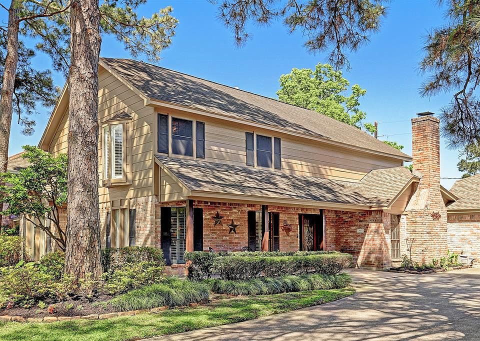Cheery home with professional landscape and plantation shutters.