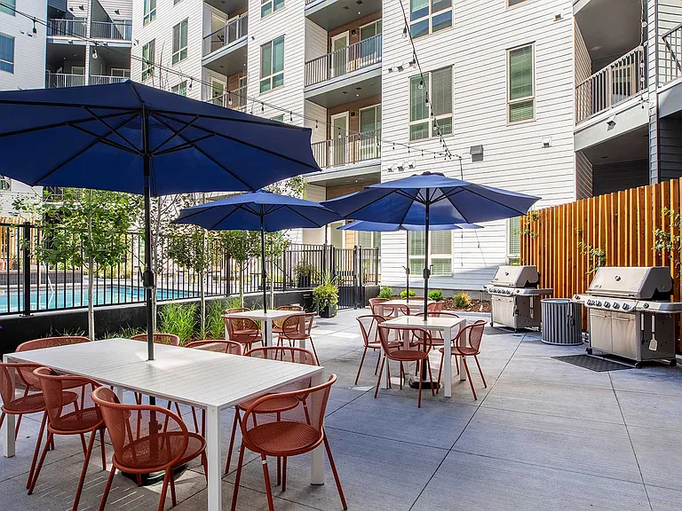 Gather outdoors with poolside dining tables, grilling stations, and shaded seating designed for relaxing and entertaining.