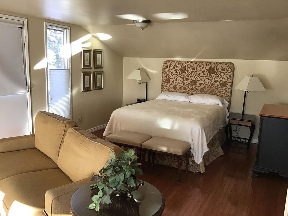 Queen bed, linens, dresser and comfy couch.