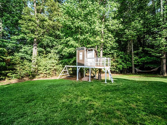 Custom built tree house with included swing. Removable hammock included.