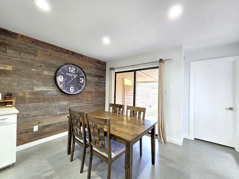 Dining area with wood accent wall