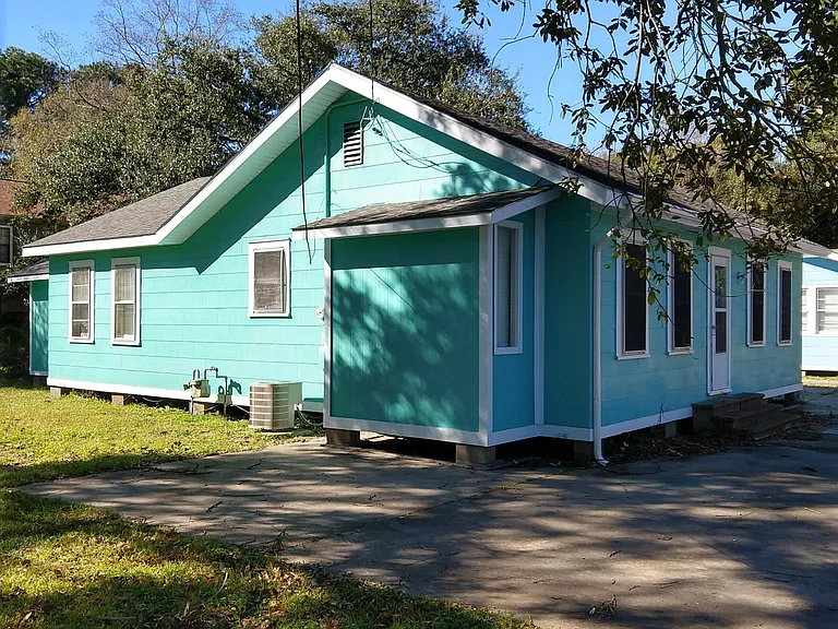 Overall photo of house from street.
Parking in front/ yard in back and side.