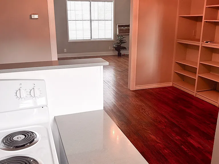 View of dining area. New modern light fixture with built in fan. Spacious bookshelves. This apartment has been renovated with fresh paint, fixtures and flooring.