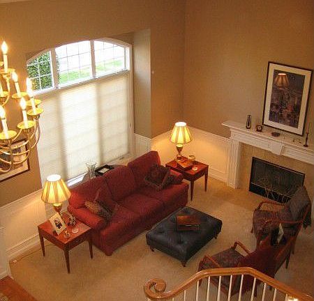 View of formal living room from upper level. Notice the 2 story vaulted ceiling and gas fireplace gr