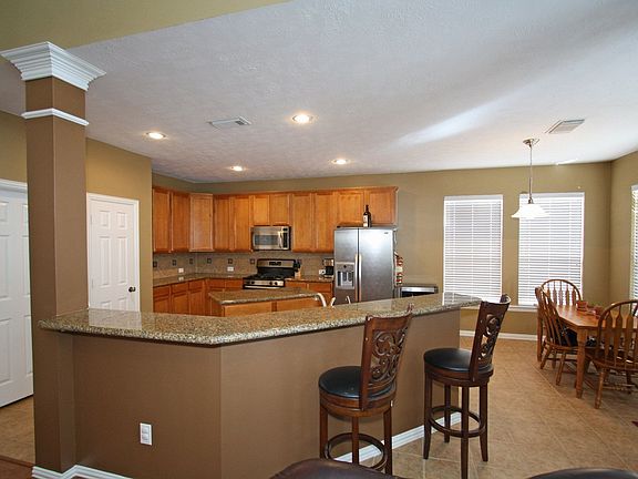 Large breakfast bar provides extra seating with nearby breakfast area.