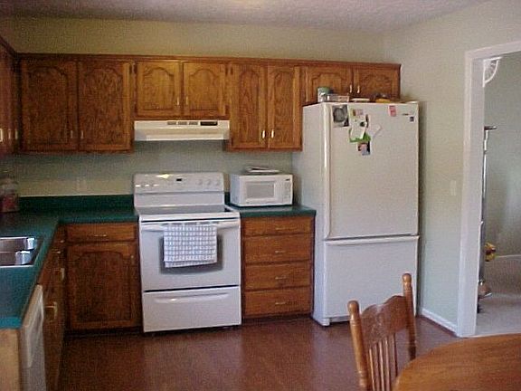 Lots of oak cabinets and beautiful hardwood laminate flooring