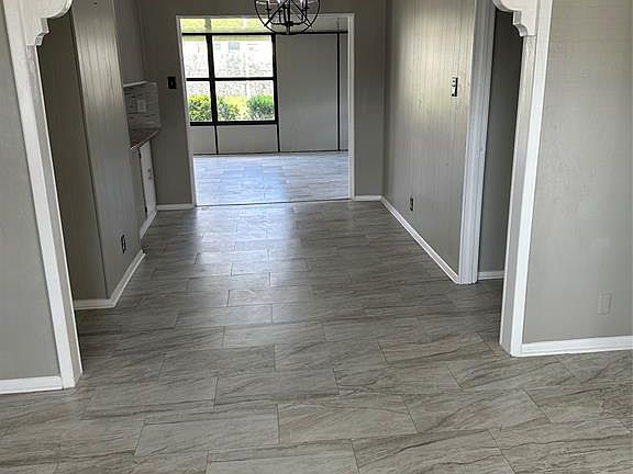 View into dining area between living and family rooms