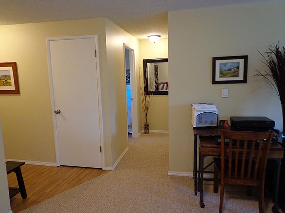 Hallway to bedrooms, entry with laminate flooring.