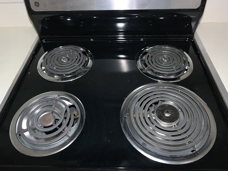 Apartment size stove top and oven.