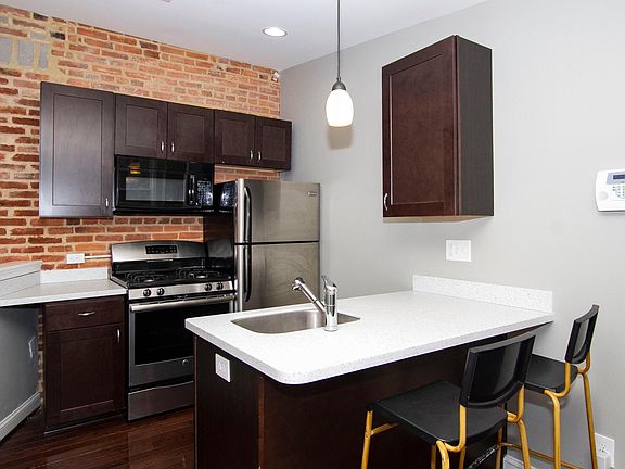 Kitchen with stainless appliances, dishwasher & granite countertops & island