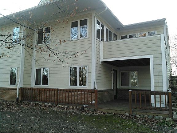 Rear view of condo. Note balcony on upper level and large deck on lower level.