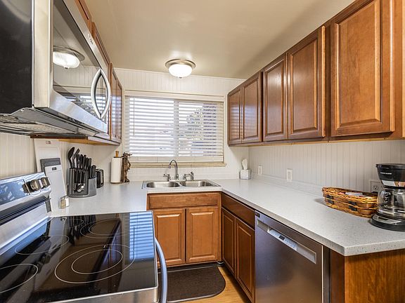 Kitchen has dishwasher, microwave, oven, disposal, and large refrigerator.