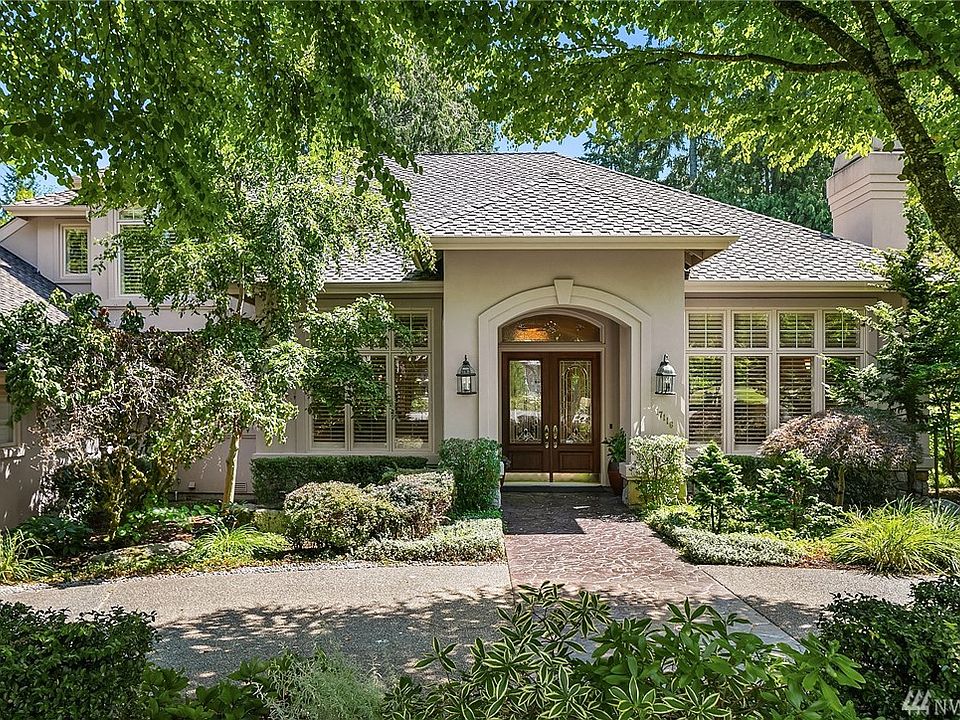 Tucked at the end of a beautiful cul de sac...an elegant circle driveway greets you. Garages are along the side of the home, as is a hidden "boat house."