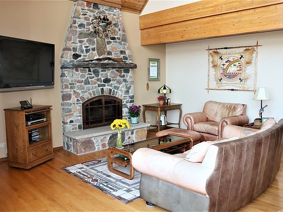 Family Room showcases a stone woodburning fireplace.