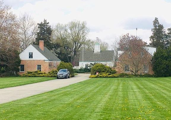 The house for rent is on the left side of the driveway