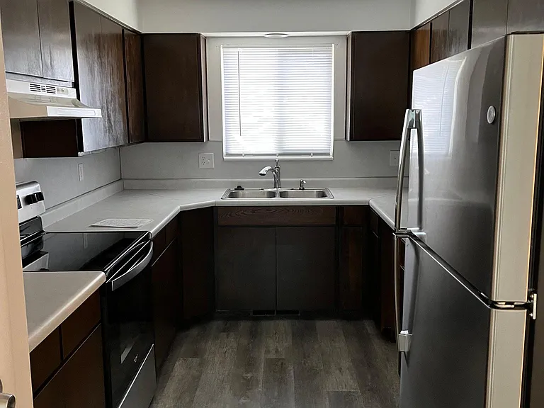 Kitchen with new fridge stove and dishwasher