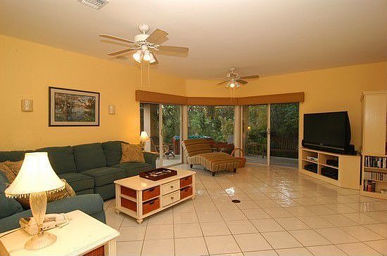 Spacious Family Room overlooks Roofed Natural Stone Patio