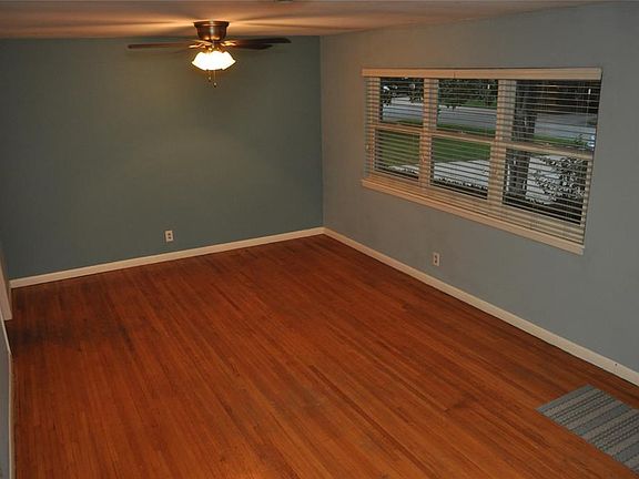 Great room connected to the front door (on right) with a view facing the street. Window blinds, ceiling fan with lights, and energy-efficient windows make this your ideal living room.
