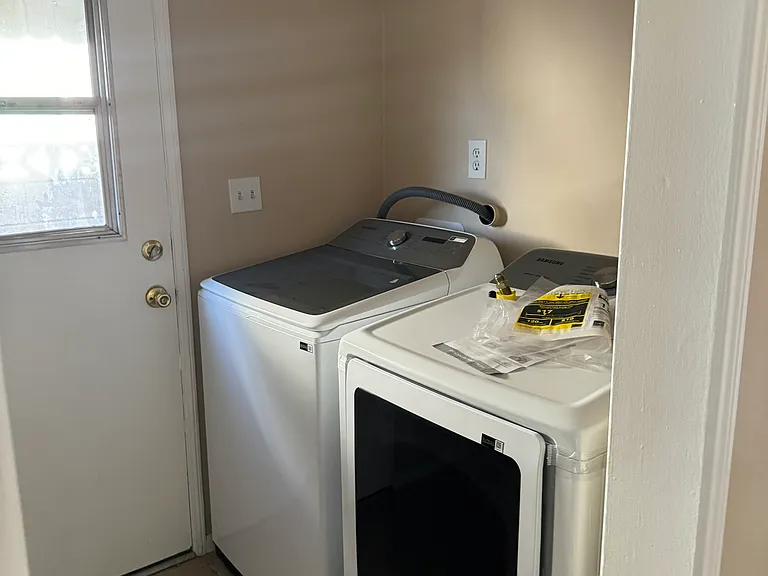 Laundry room with new washer and dryer.