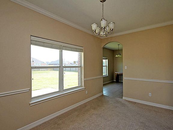 Formal dining room has a contemporary chair rail and neutral colors!
