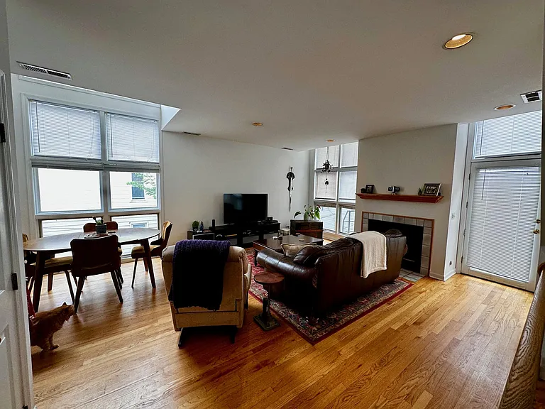 LIVING ROOM WITH SOUTH AND WEST SUN. WOODBURNING FIREPLACE AND DOOR TO PRIVATE DECK