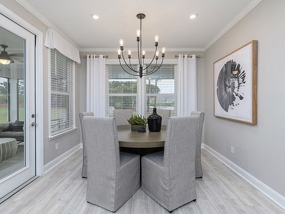 Classy Dining Room with a chandelier, nestled just off of the open Kitchen area.