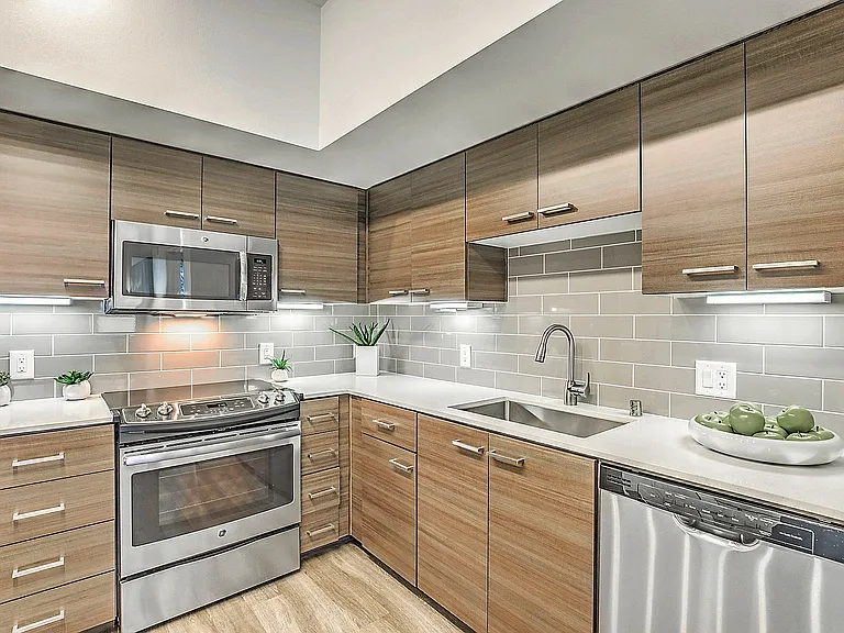Modern kitchen with sleek stainless steel appliances in Tempo at Riverpark