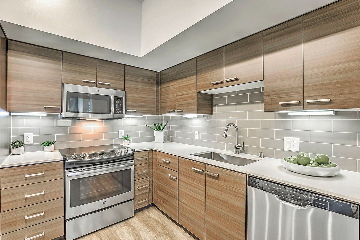 Modern kitchen with sleek stainless steel appliances in Tempo at Riverpark