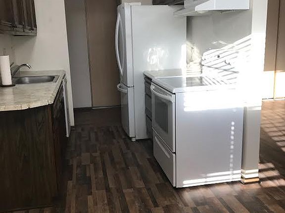 Kitchen with double door fridge and drawer freezer, glass flat top stove