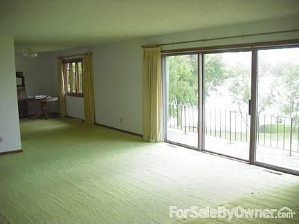 Living Room looking into Dining Room : 3 large windows look out over the lake. Very bright and airy.