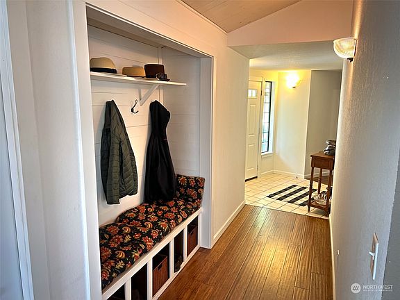 Off front entry convenient coat rack, bench and shoe storage.>