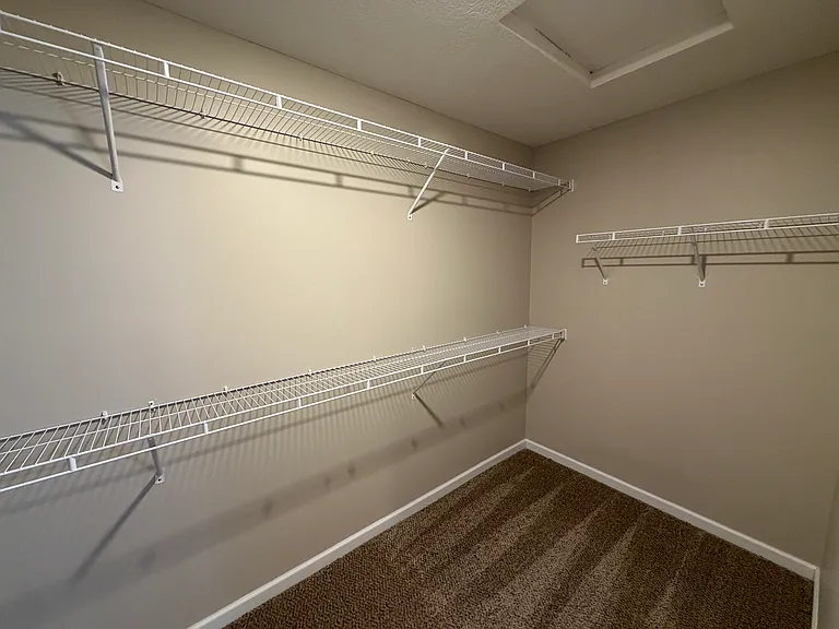 Another view of the spacious walk-in closet in the primary bathroom.